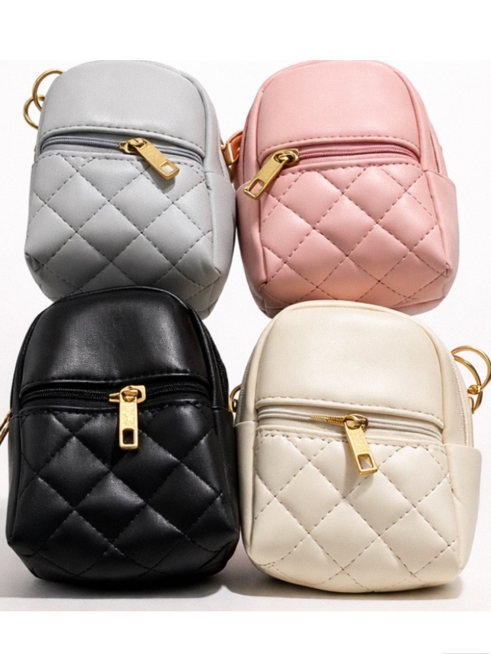 Mini backpack keychain charms, blue, pink, black, cream colors.